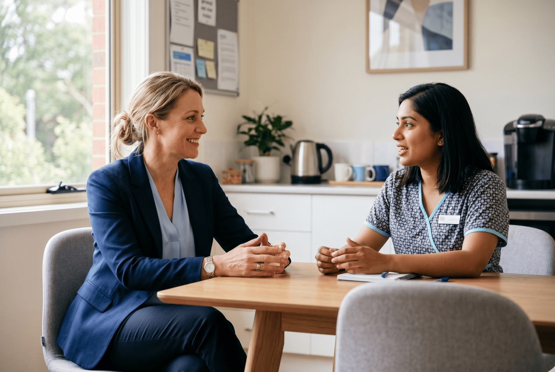Managing staff in a medical practice – practice manager team meeting Australian practice manager in a one-on-one team meeting with a GP practice staff member